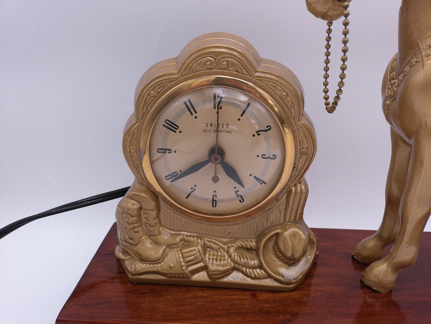 mid-century United self-starting horse clock