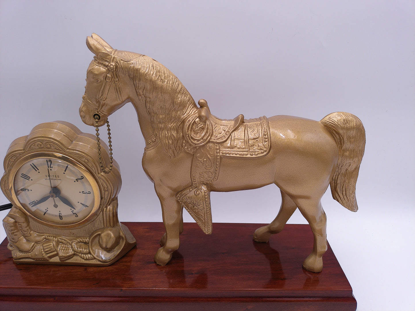 mid-century United self-starting horse clock