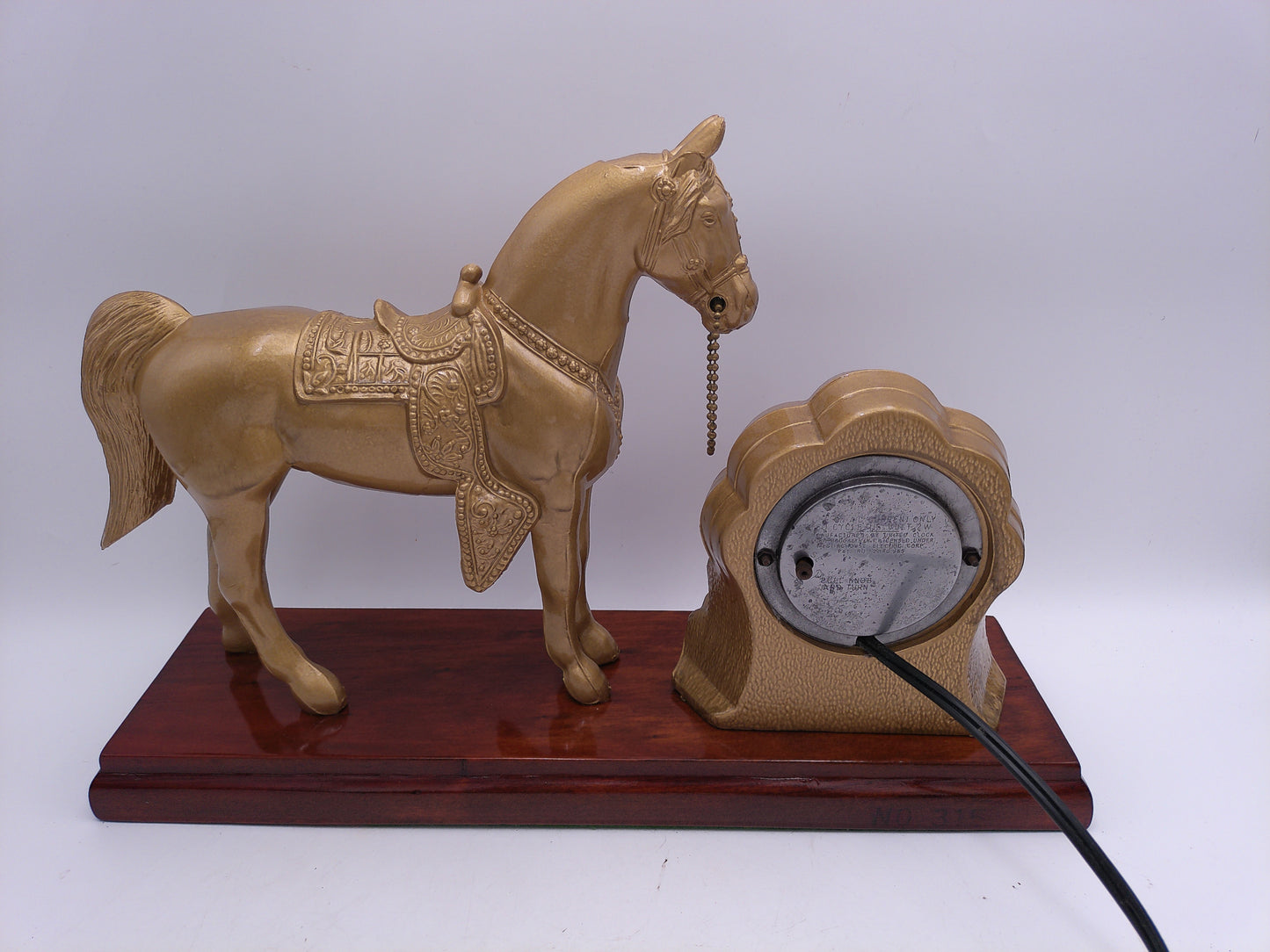 mid-century United self-starting horse clock