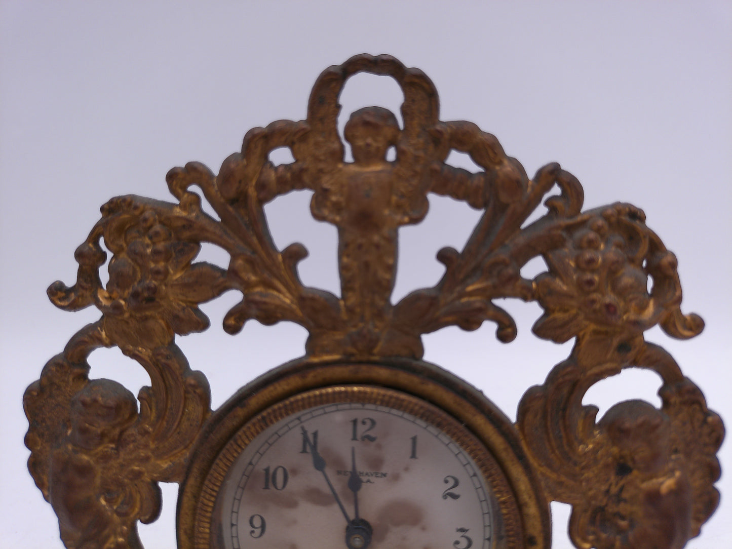 New Haven Clock with Brass Stand and Angels Antique