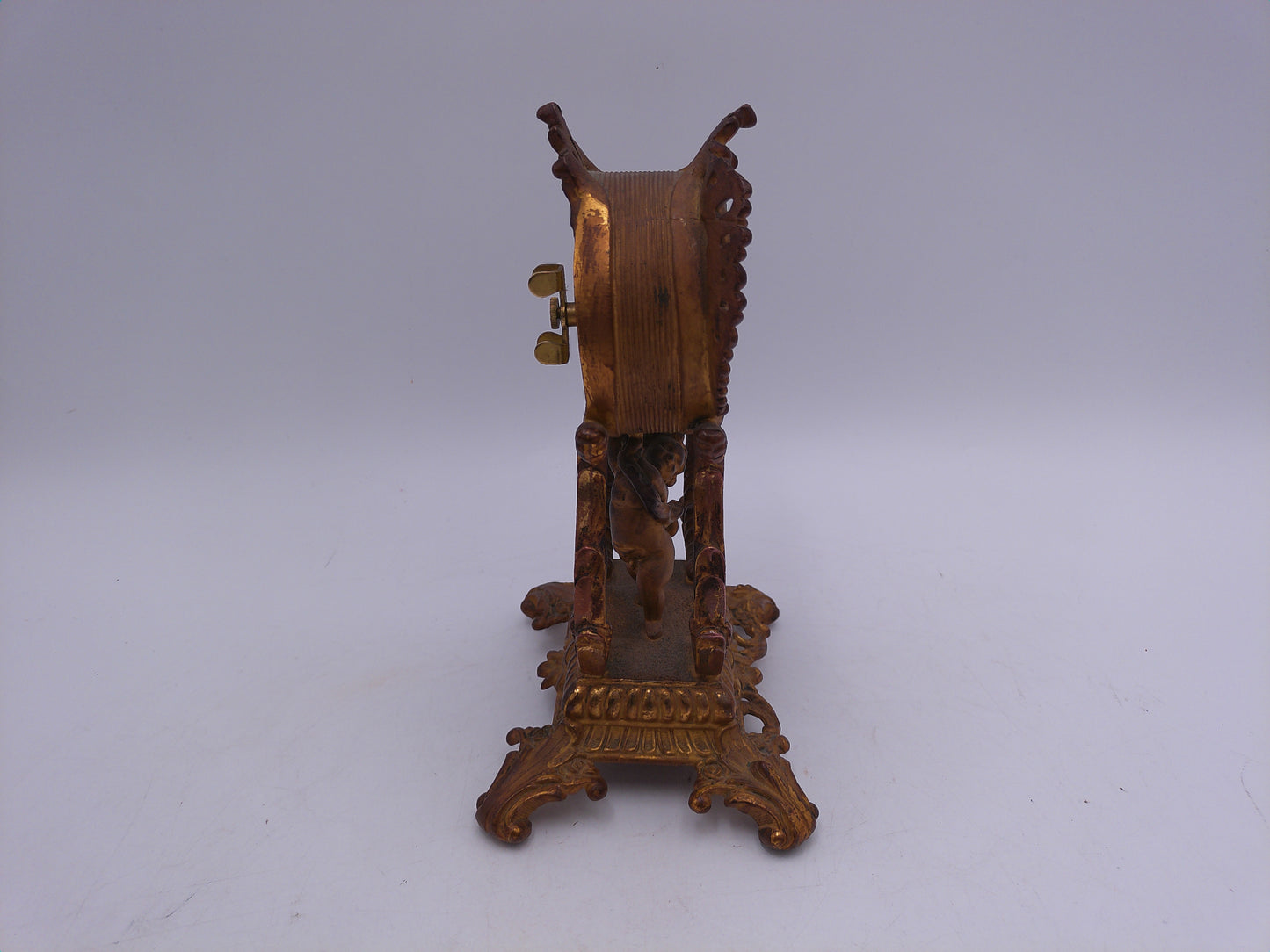 Waterbury Clock Co. Brass Table Clock  featuring figural cherub and scroll motif Vintage