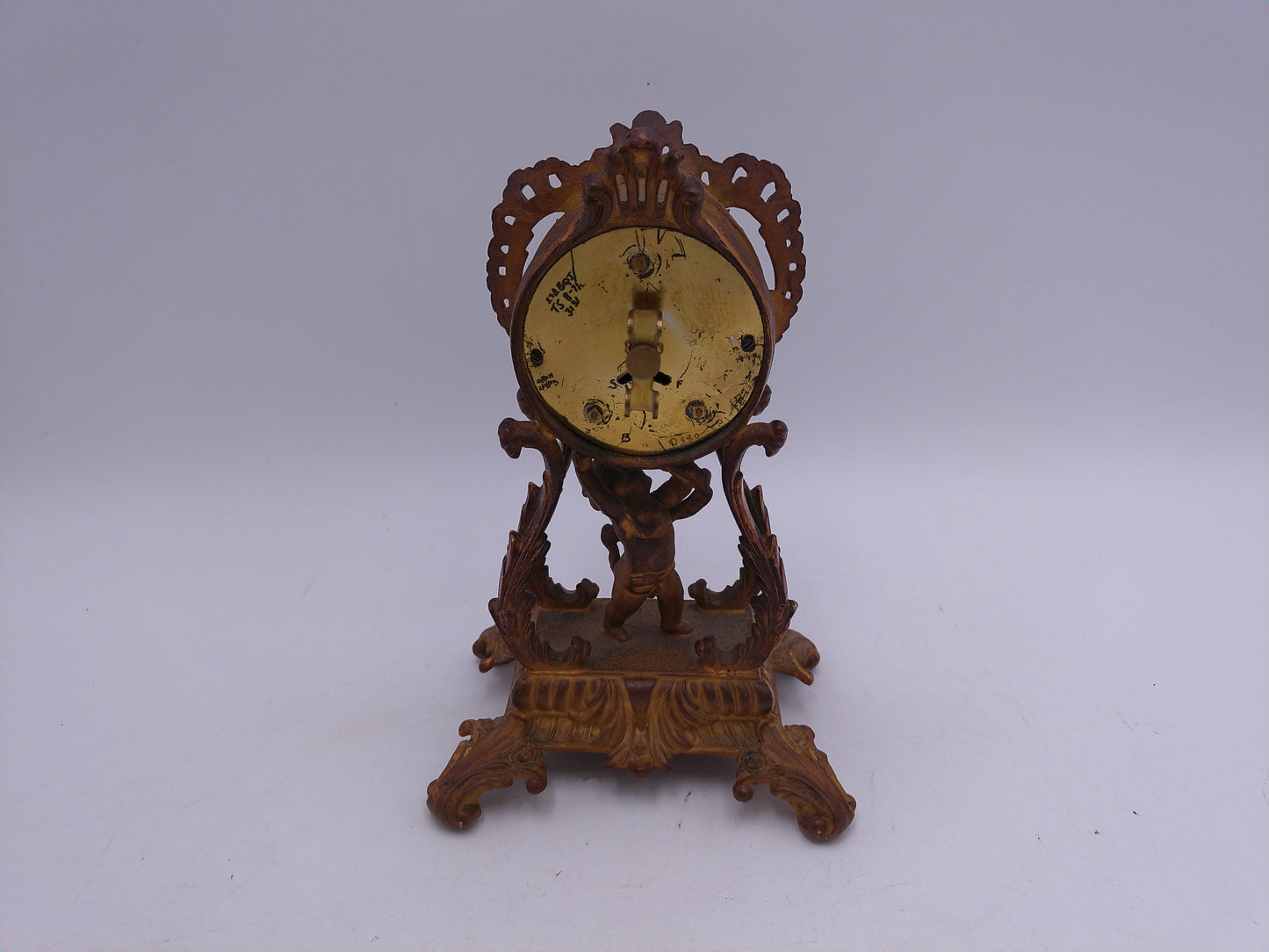 Waterbury Clock Co. Brass Table Clock  featuring figural cherub and scroll motif Vintage