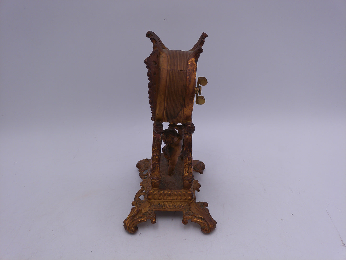 Waterbury Clock Co. Brass Table Clock  featuring figural cherub and scroll motif Vintage