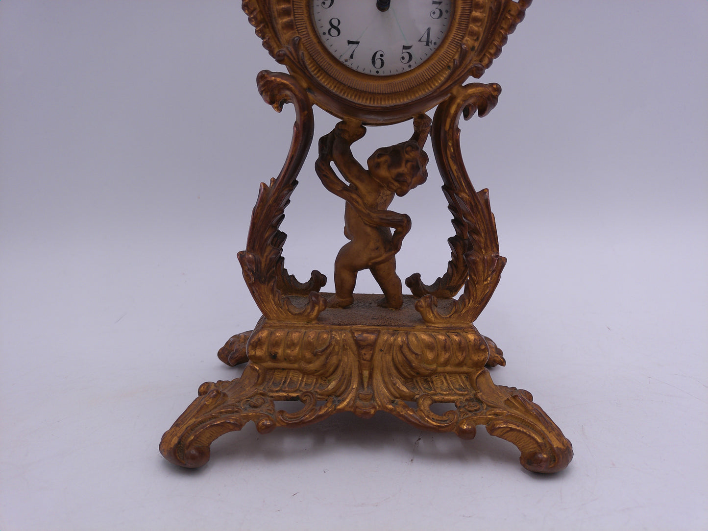 Waterbury Clock Co. Brass Table Clock  featuring figural cherub and scroll motif Vintage