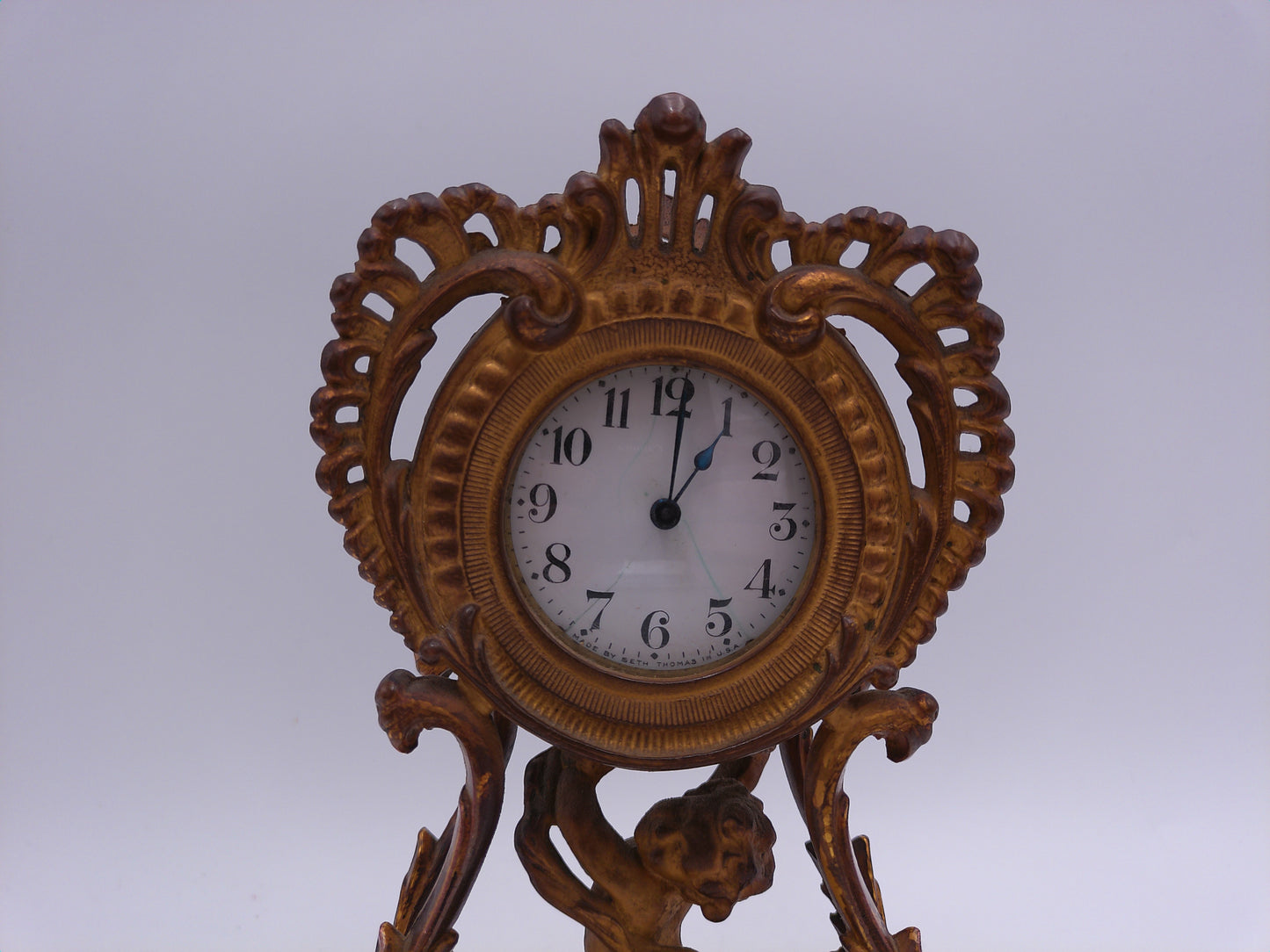 Waterbury Clock Co. Brass Table Clock  featuring figural cherub and scroll motif Vintage