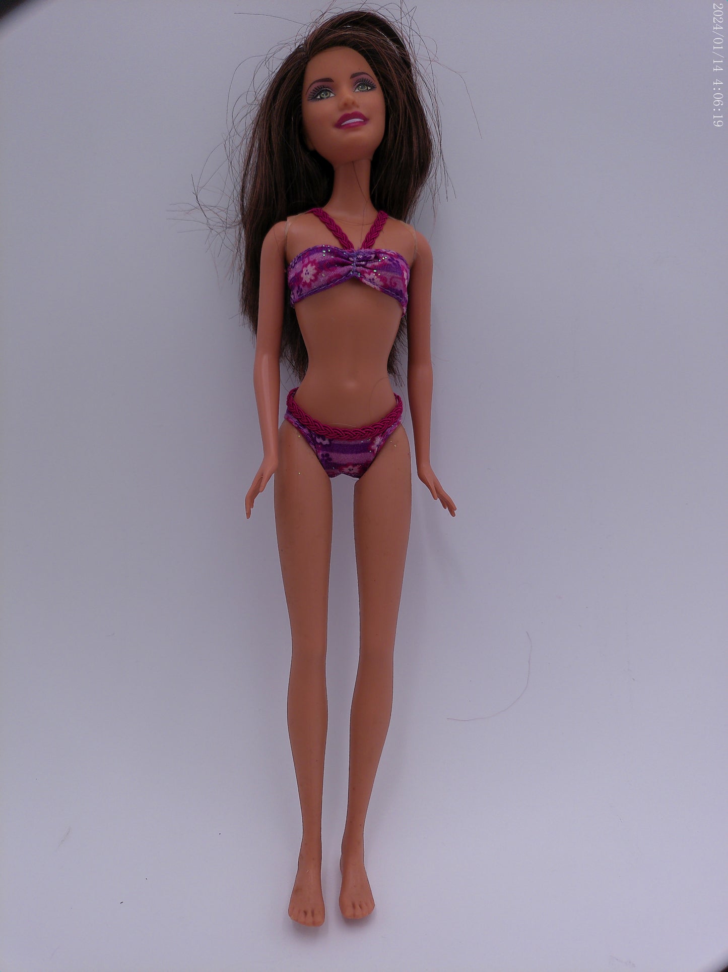 4 Vintage Barbies one is a Disney Barbie