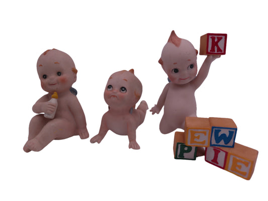 Kewpie set of 3 one with playing with blocks ans one with Bottle