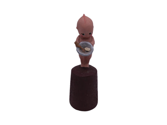Kewpie Standing on Log holding  dish or bowl
