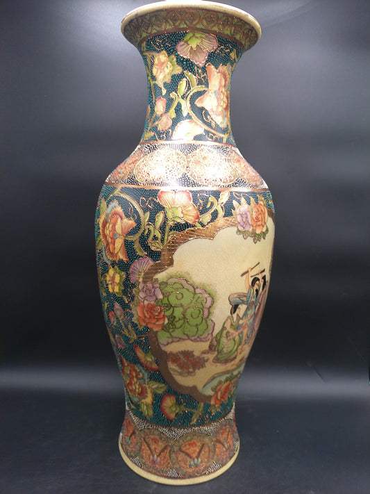 Decorative vase with floral and landscape design on a dark background