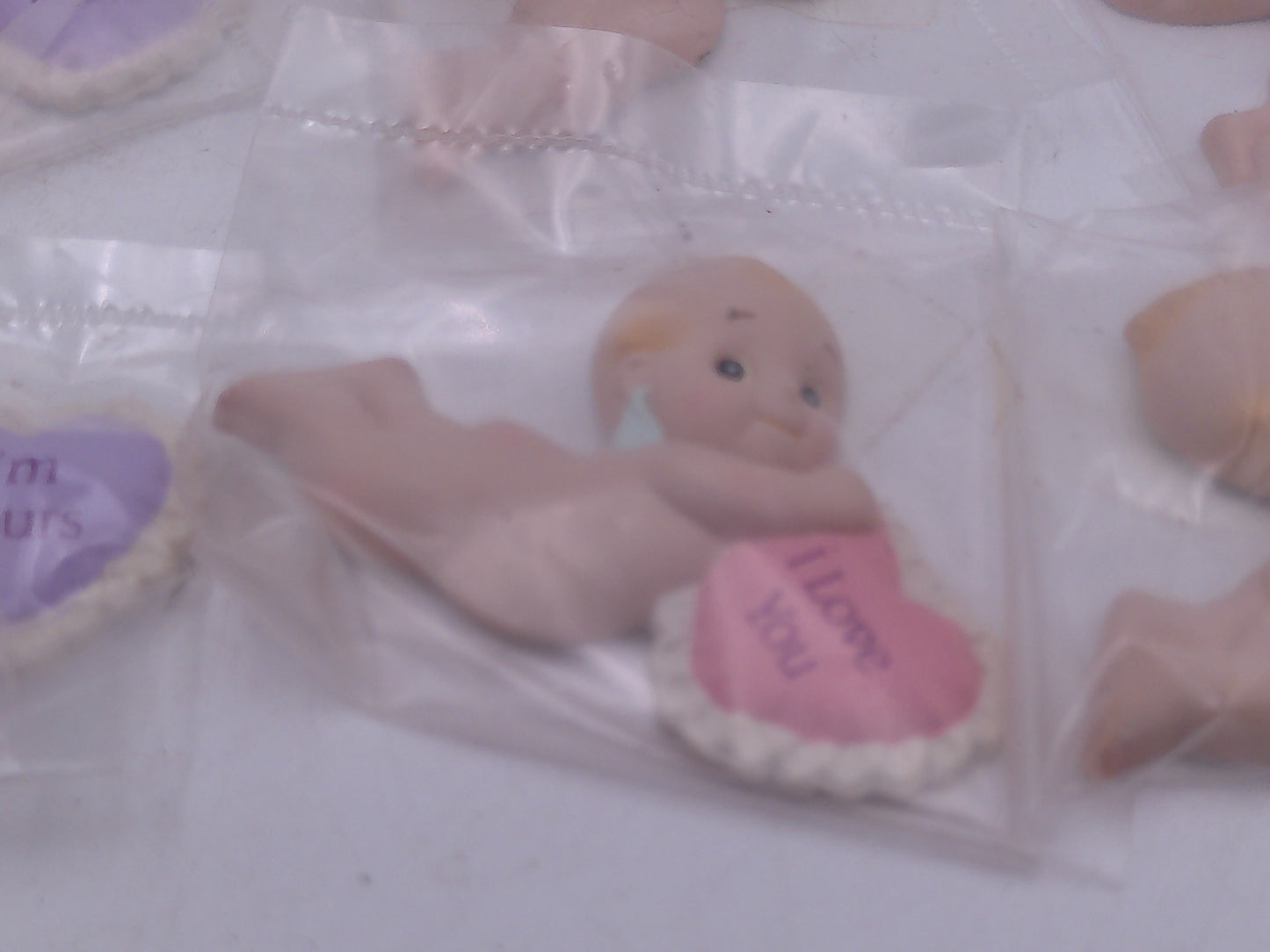 Kewpie Valentine figures with heart message in Jar